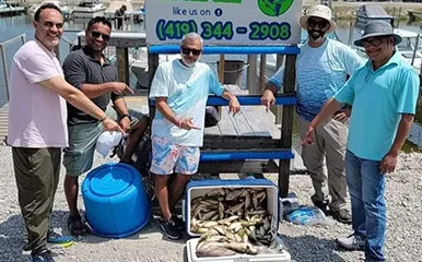 Group of five anglers with a bountiful catch at More Gooder Fishing Charters, showcasing a successful day of fishing at Lake Erie marina, September 6, 2023.